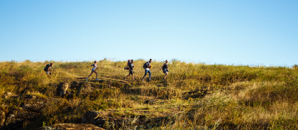 young-beautiful-friends-travelers-with-backpacks-walking-canyon.png -